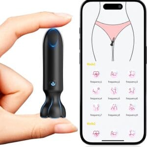 Mini wearable vibrator held between fingers next to smartphone showing app with remote vibration modes