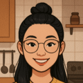 Illustration of a smiling woman with glasses and a top bun, standing in a cozy kitchen with cooking utensils in the background